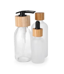 Photo of Different glass bottles with dropper and dispenser cap isolated on white