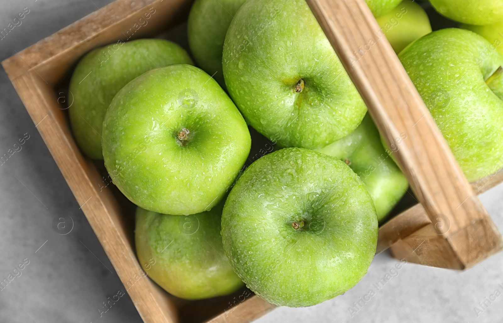 Photo of Wooden basket with fresh green apples on table