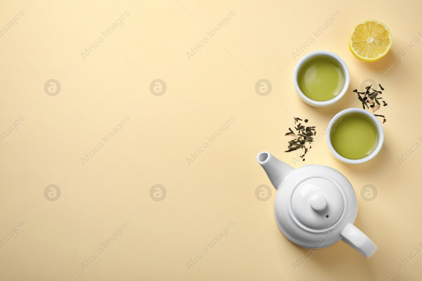 Photo of Flat lay composition with green tea on beige background. Space for text