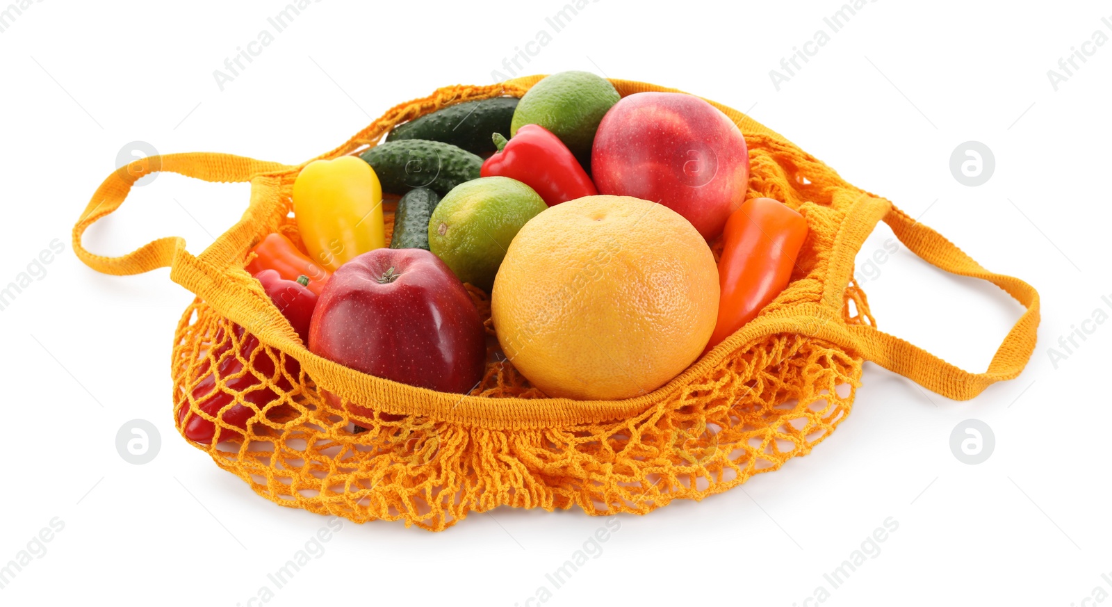 Photo of String bag with vegetables and fruits isolated on white