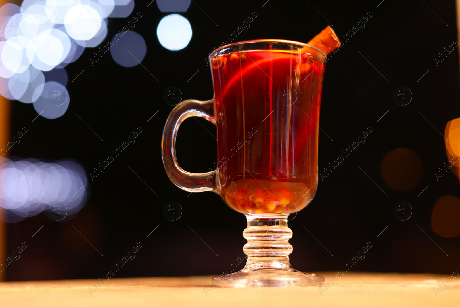 Photo of Tasty aromatic mulled wine on table at winter fair