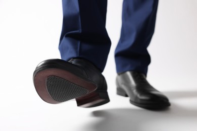 Photo of Businessman in leather shoes on white background, closeup