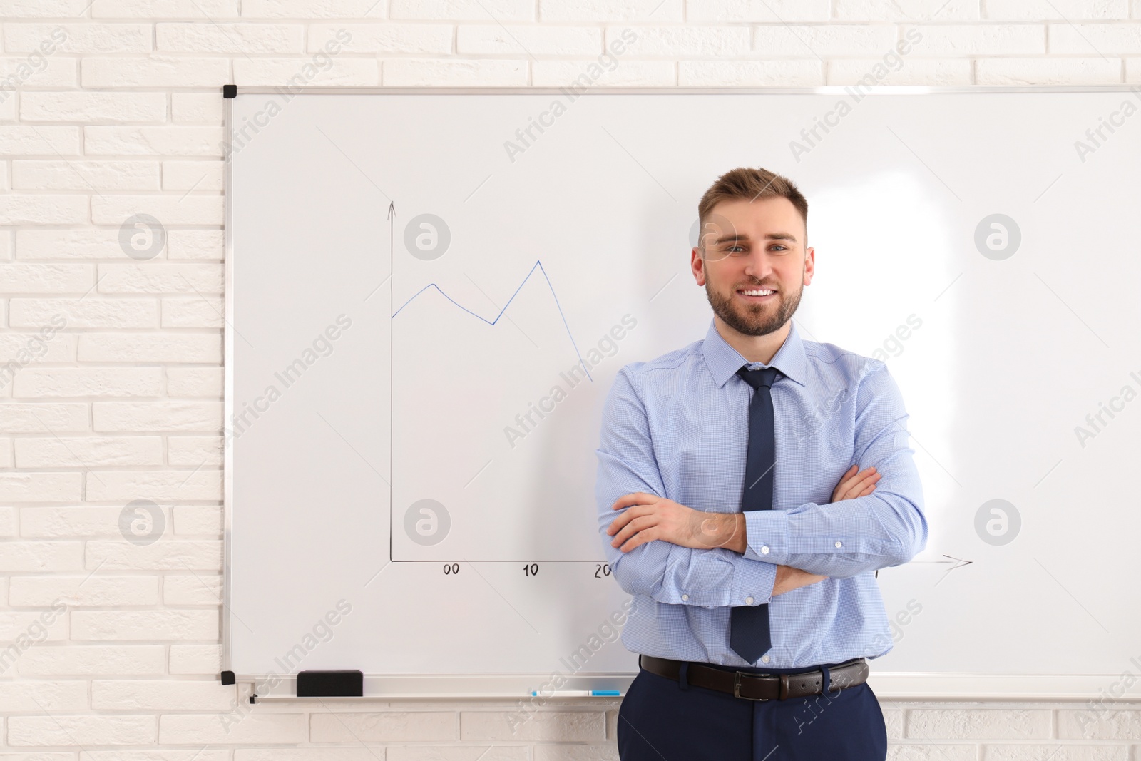 Photo of Professional business trainer near whiteboard in office