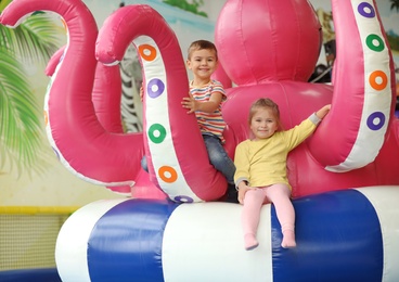 Cute little children playing at indoor amusement park
