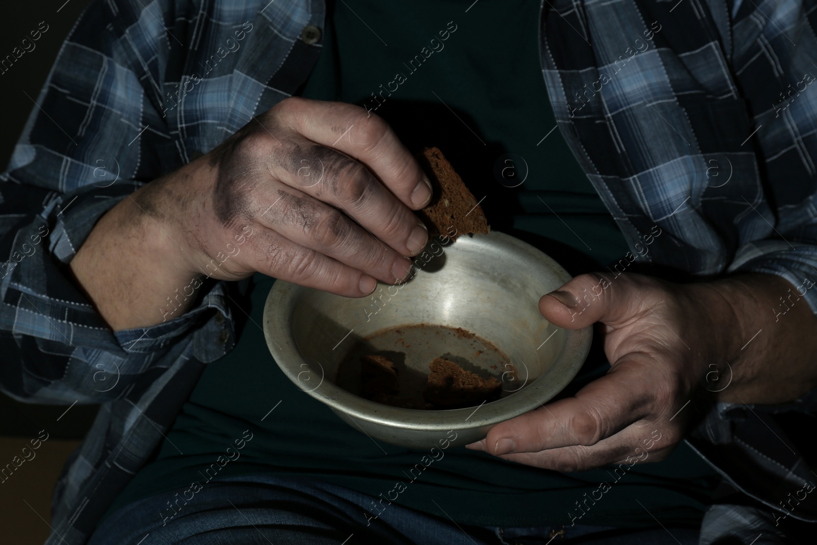 Photo of Poor senior man with bread and bowl, closeup