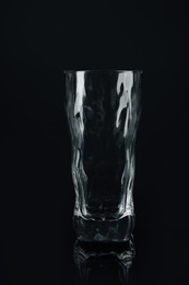 Photo of New empty tall glass on black background