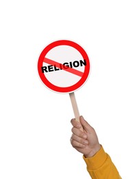 Image of Atheism concept. Man holding prohibition sign with crossed out word Religion on white background