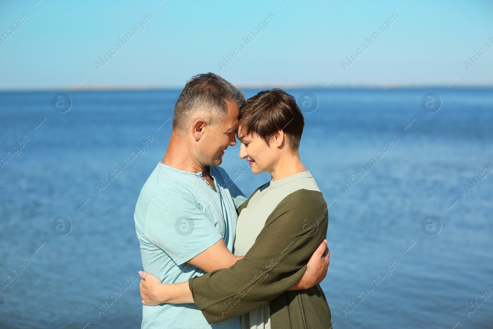 Photo of Happy mature couple at beach on sunny day