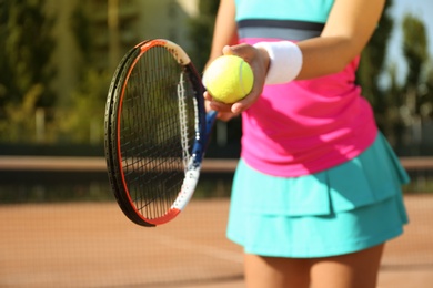 Sportswoman preparing to serve tennis ball at court, closeup