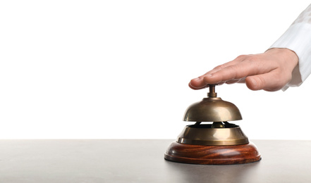 Photo of Woman ringing hotel service bell at grey stone table