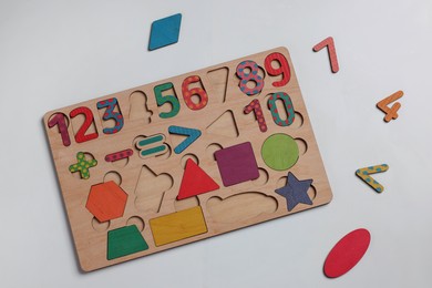 Wooden math game kit for children on white table, flat lay