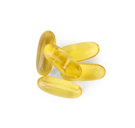 Photo of Many yellow vitamin capsules isolated on white, top view