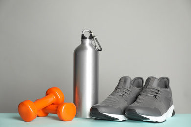 Photo of Composition with fitness equipment on light table