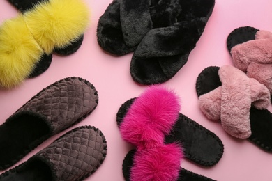 Different soft slippers on light pink background, flat lay