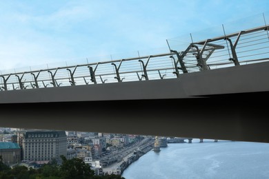 Photo of KYIV, UKRAINE - AUGUST 11, 2022: Pedestrian park bridge over Dnipro river