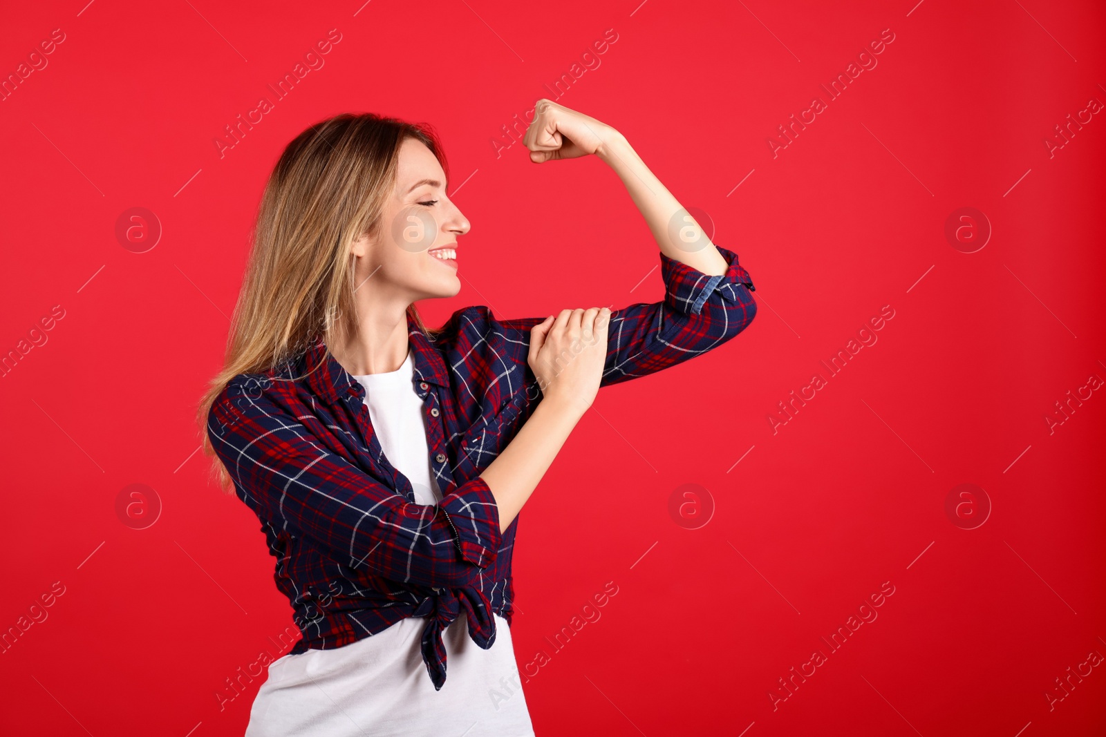 Photo of Strong woman as symbol of girl power on red background, space for text. 8 March concept