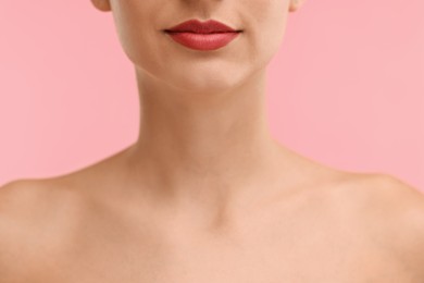 Photo of Woman with beautiful lips on pink background, closeup