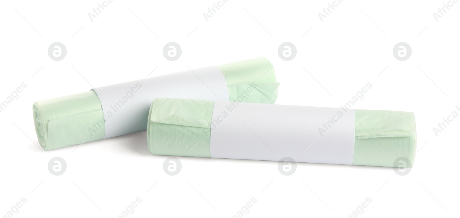 Photo of Rolls of garbage bags on white background. Cleaning supplies