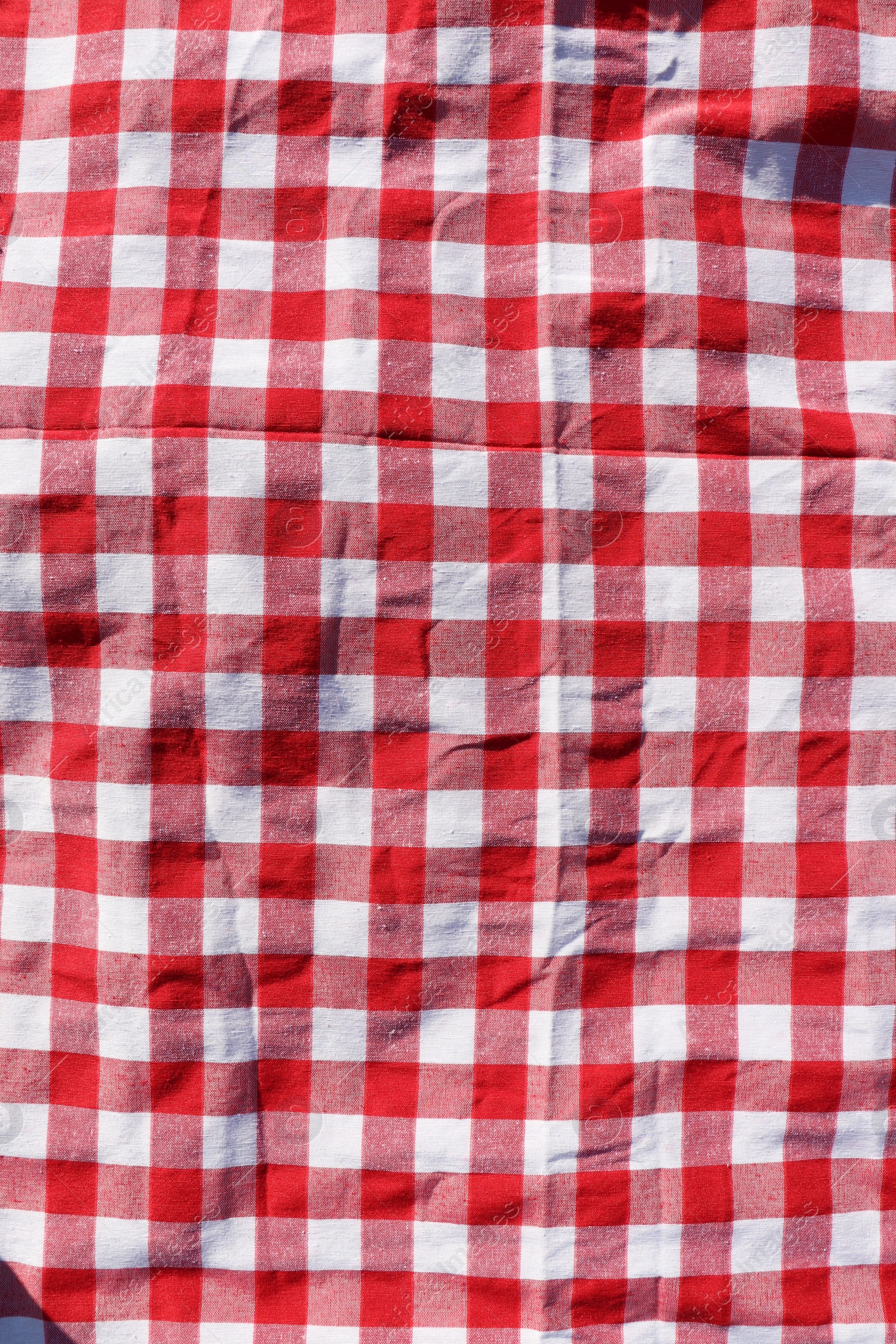 Photo of Red checkered picnic tablecloth as background, top view