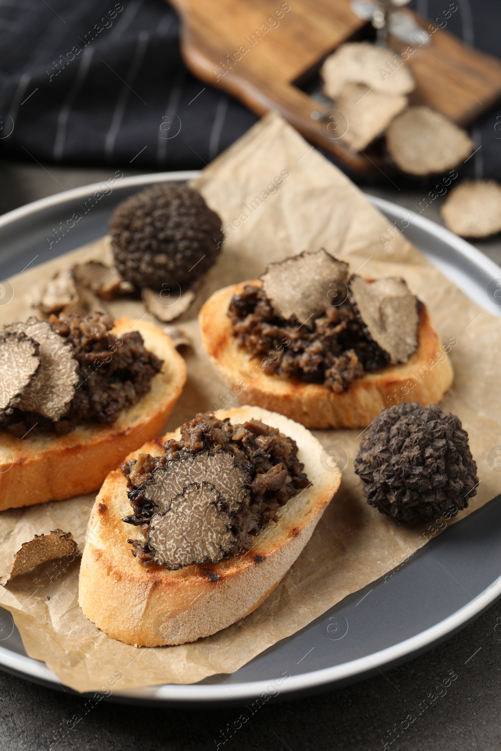 Photo of Delicious bruschettas with truffle sauce on grey table, closeup