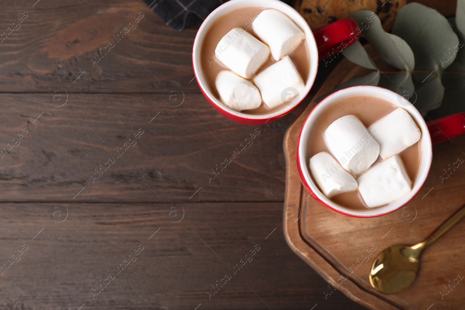 Photo of Flat lay composition of tasty cocoa with marshmallows on wooden table. Space for text