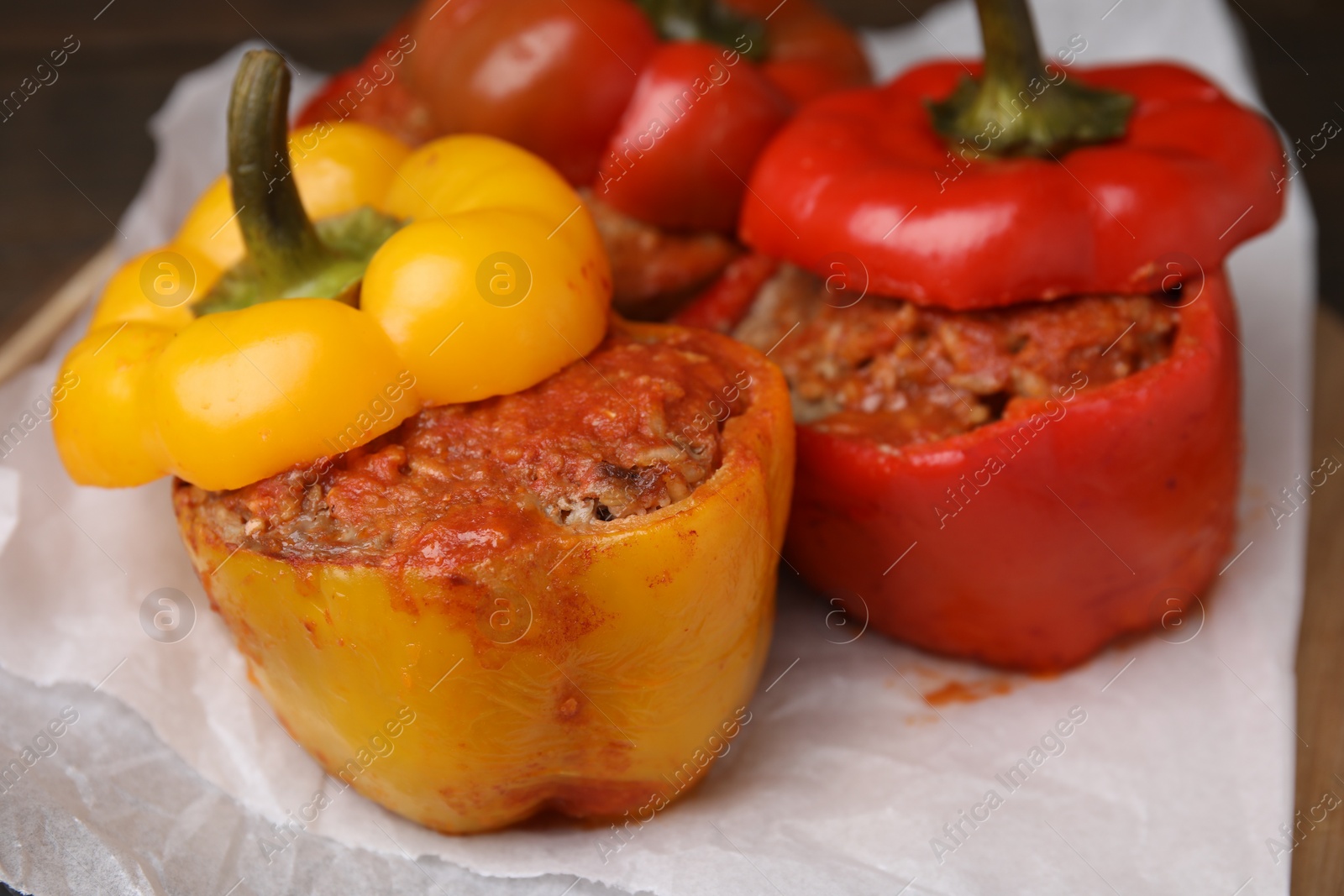 Photo of Delicious stuffed bell peppers served on table, closeup