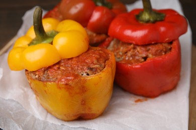 Photo of Delicious stuffed bell peppers served on table, closeup