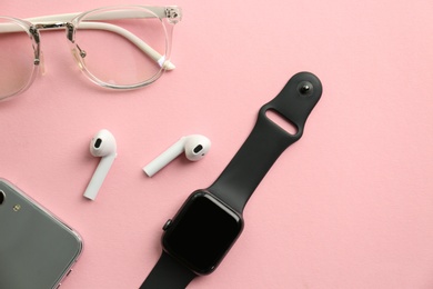 Photo of Flat lay composition with stylish smart watch on pink background