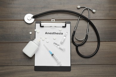 Photo of Flat lay composition with word Anesthesia and drugs on wooden table