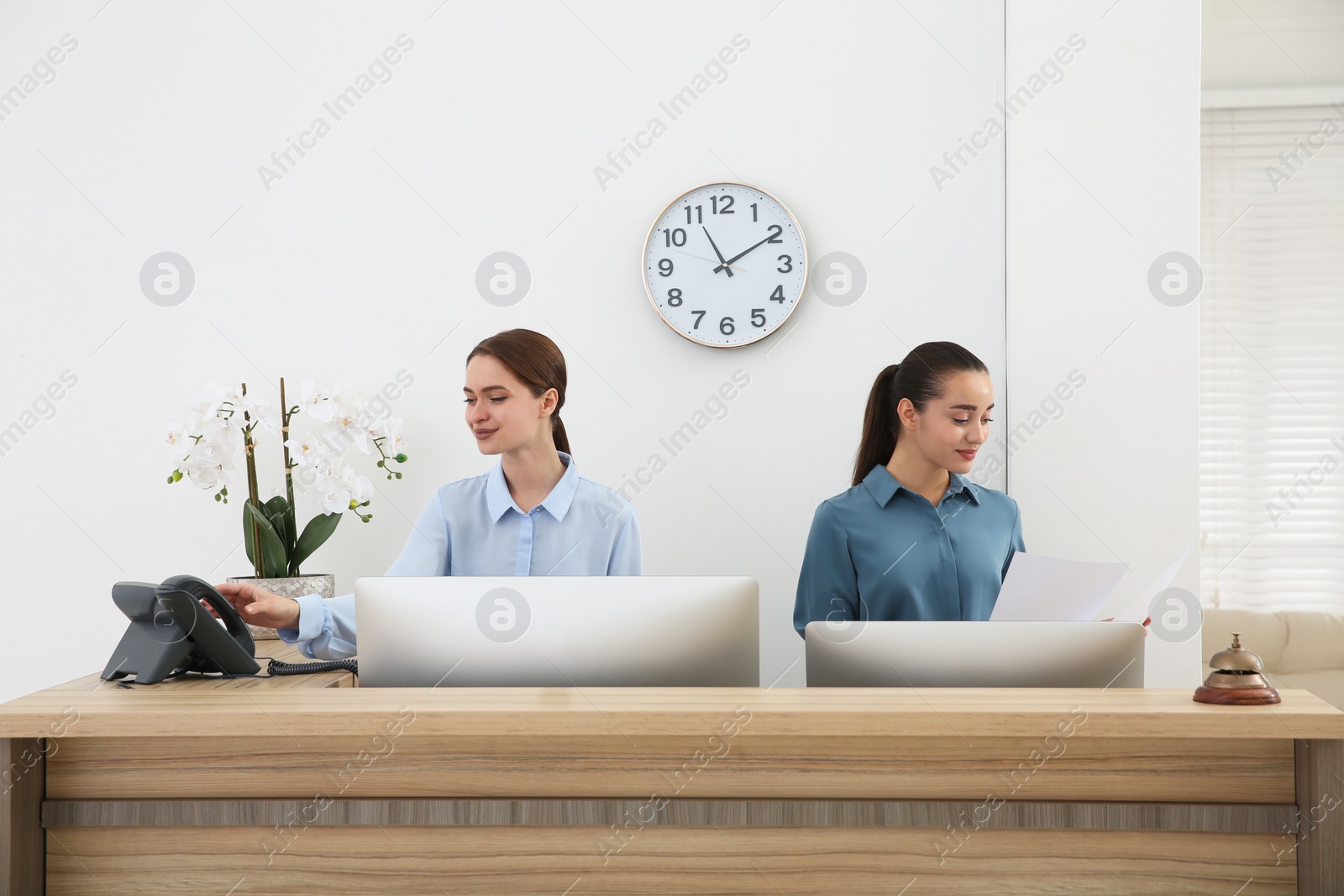 Photo of Beautiful receptionists working at counter in hotel