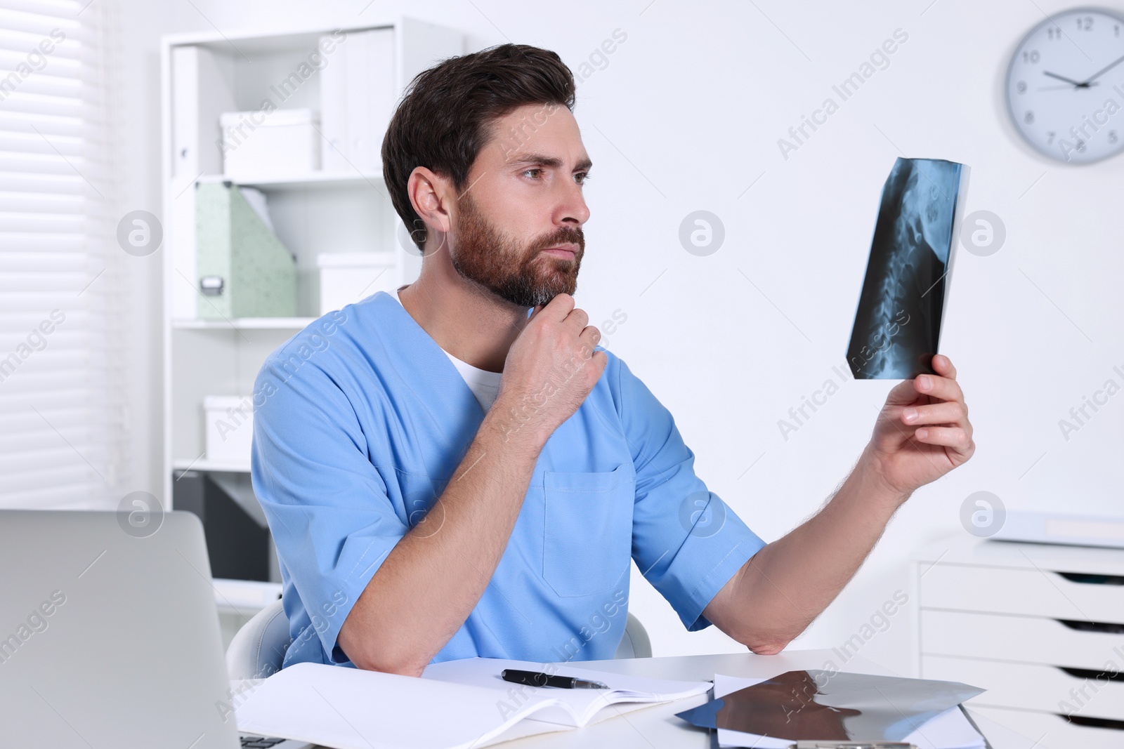 Photo of Doctor examining neck MRI scan in hospital