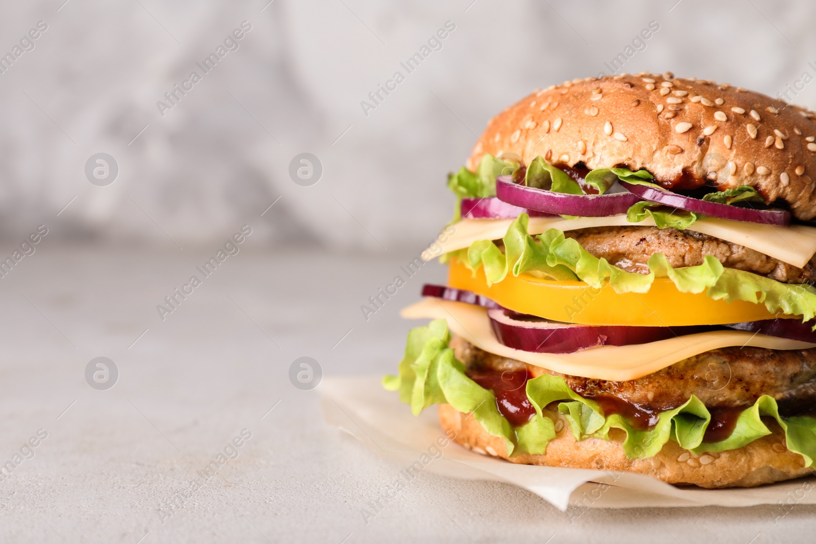 Photo of Delicious hamburger on table. Space for text