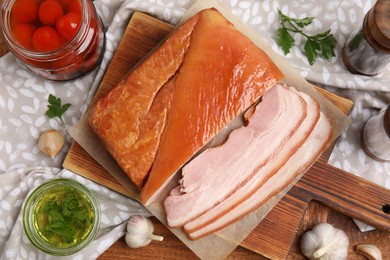 Photo of Flat lay composition with delicious smoked bacon on wooden table