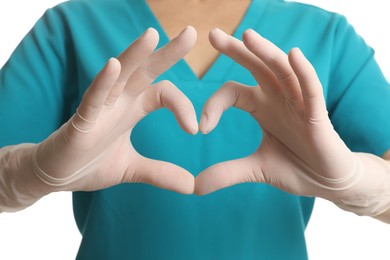 Doctor in medical gloves making heart with her hands on white background, closeup
