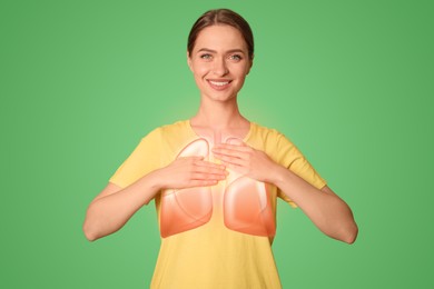 Image of Young woman holding hands near chest with illustration of lungs on green background, closeup