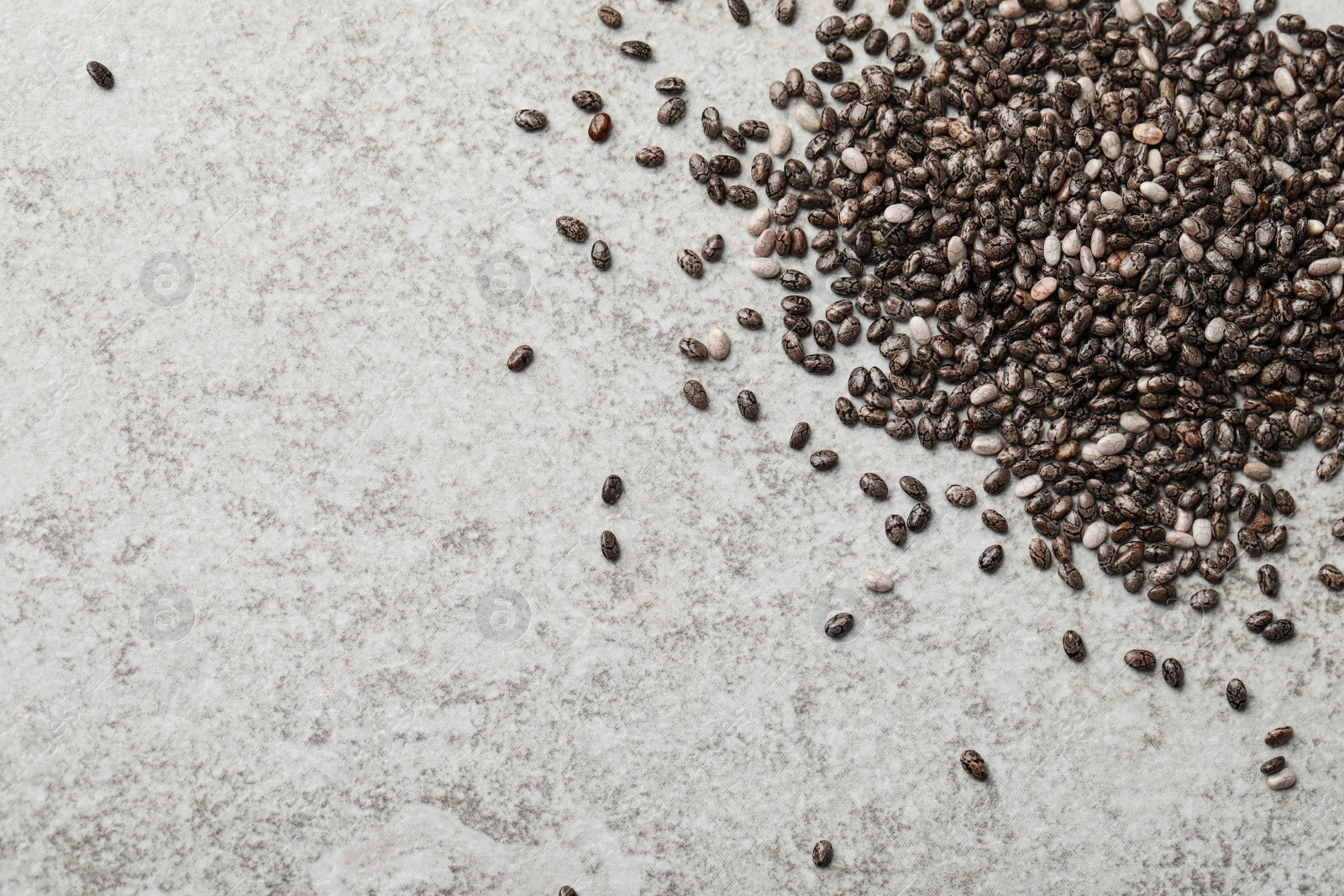 Photo of Pile of chia seeds on light grey table, flat lay. Space for text