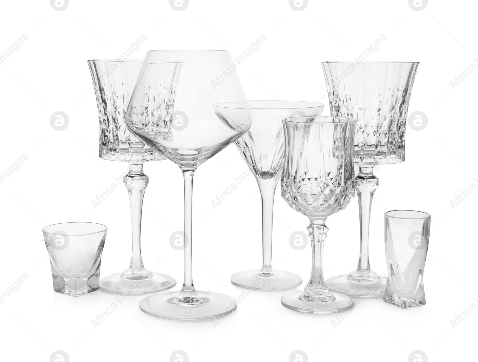 Photo of Different elegant empty glasses isolated on white