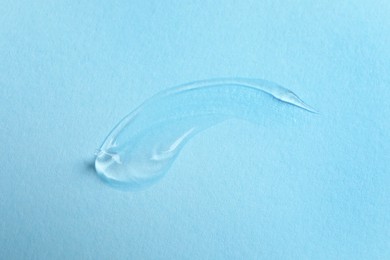 Photo of Swatch of cosmetic gel on light blue background, above view