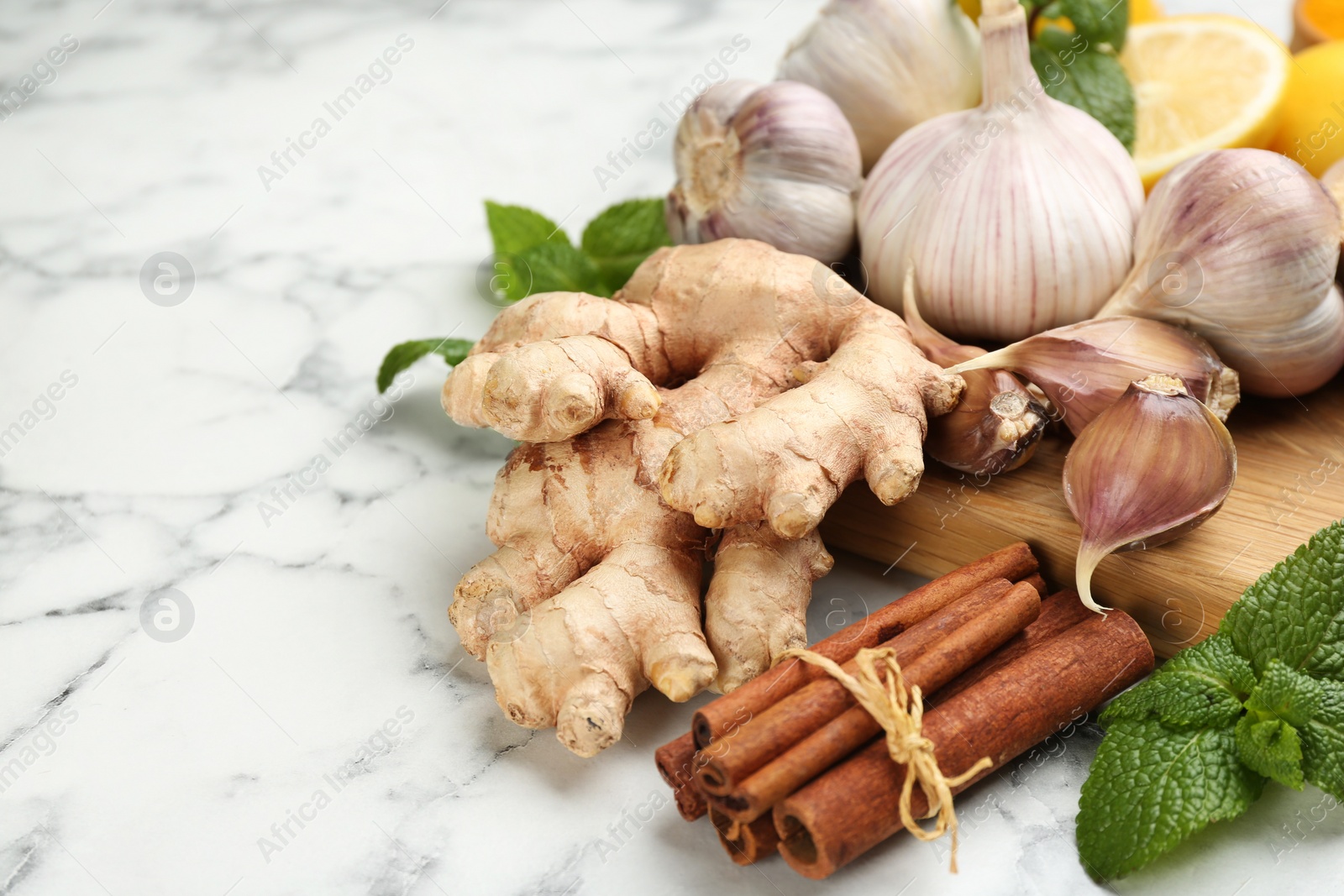 Photo of Different fresh products on white marble table, space for text. Natural antibiotics