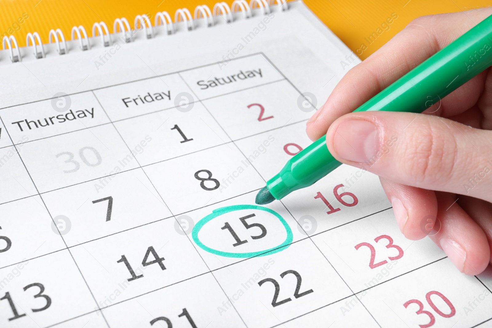 Photo of Woman marking date in calendar with felt pen, closeup