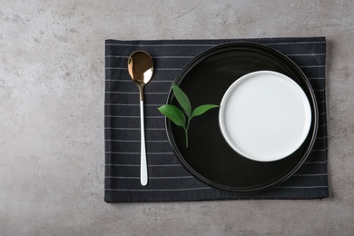 Beautiful table setting on grey background, top view