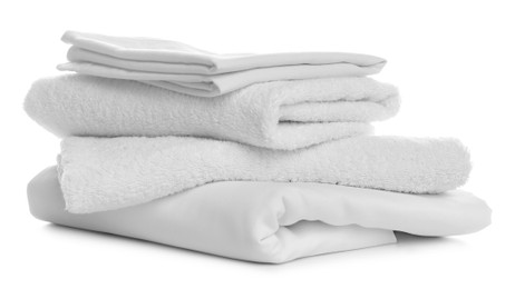 Photo of Stack of towels and bedding on white background