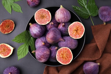 Photo of Fresh ripe purple figs on black table, flat lay