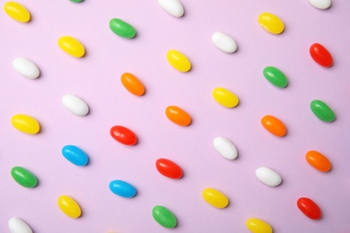 Photo of Flat lay composition with jelly beans on color background