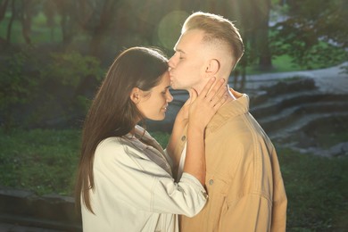 Photo of Happy young couple having good time together in park