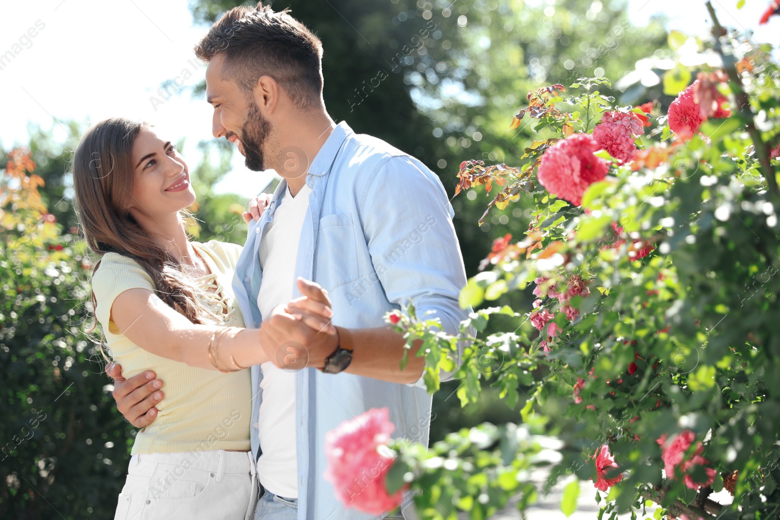 Photo of Lovely young couple dancing together in park on sunny day