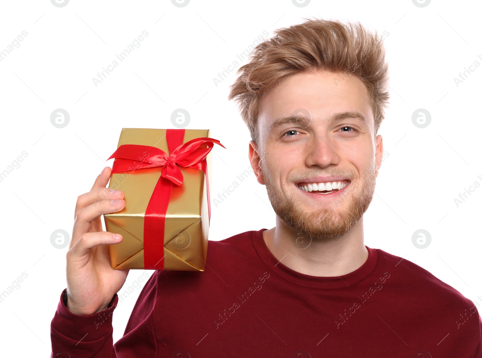 Photo of Young man with Christmas gift on white background