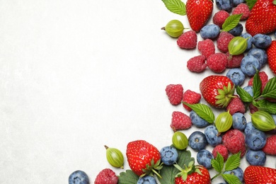 Photo of Mix of fresh berries on light table, flat lay. Space for text