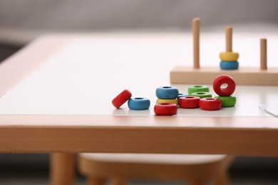 Stacking and counting game on table indoors, space for text. Educational toy for motor skills development