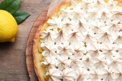 Photo of Delicious lemon meringue pie on wooden table, top view